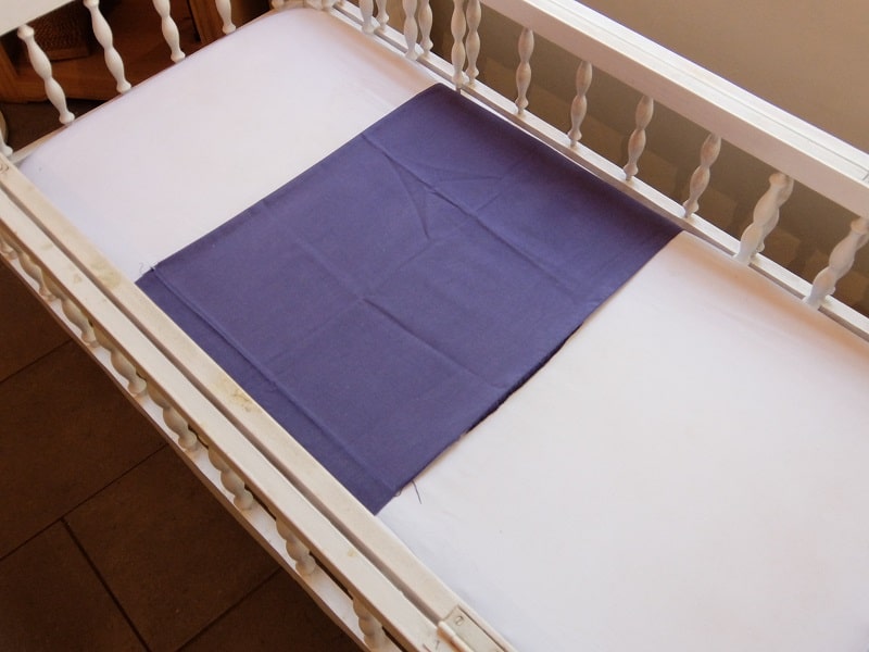 A used pillow case of moms can help get a newborn to sleep in a bassinet