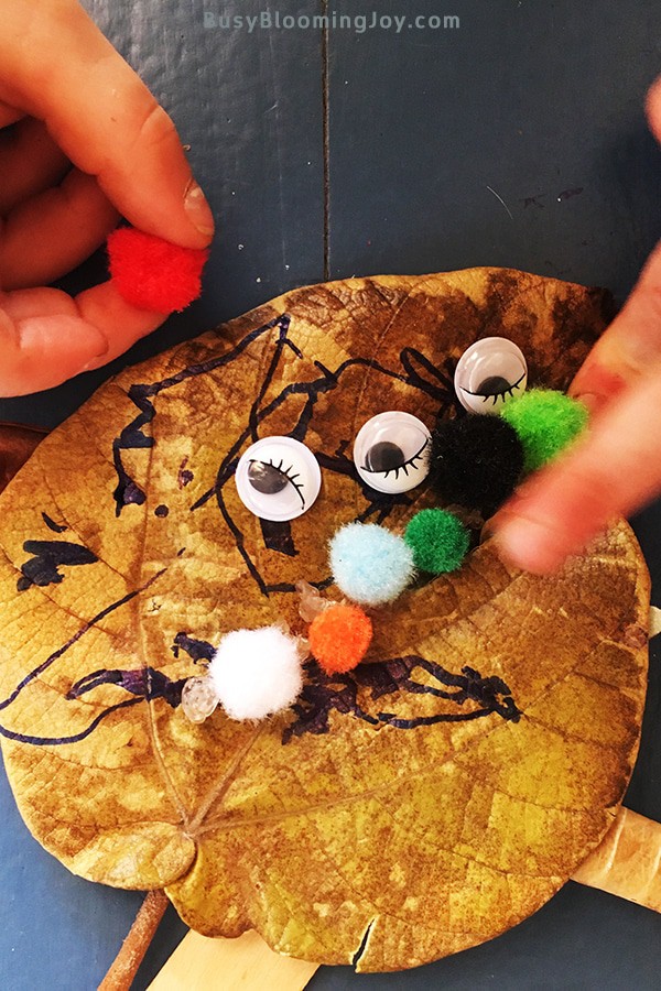 Sticking pompoms onto lead monster craft