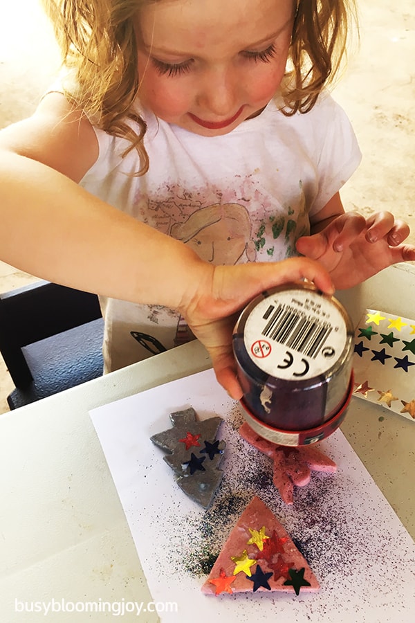 sprinkling glitter on salt dough christmas decorations