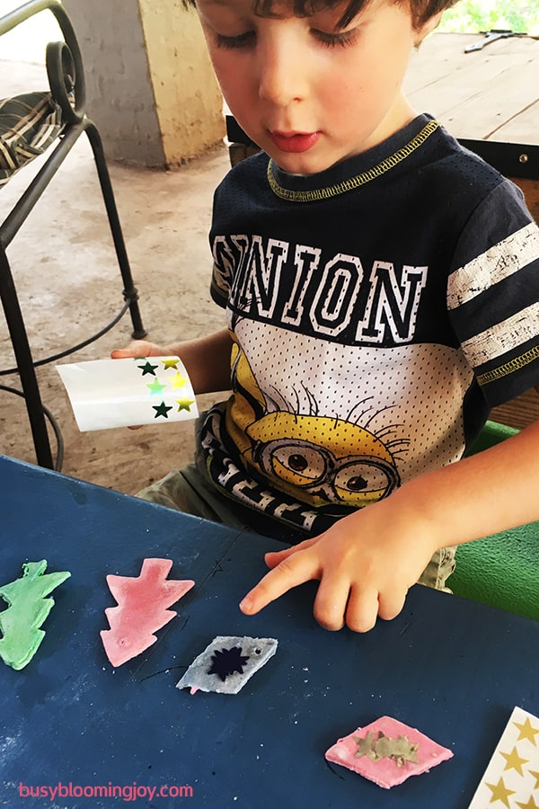 sticking stickers on salt dough Christmas tree ornaments