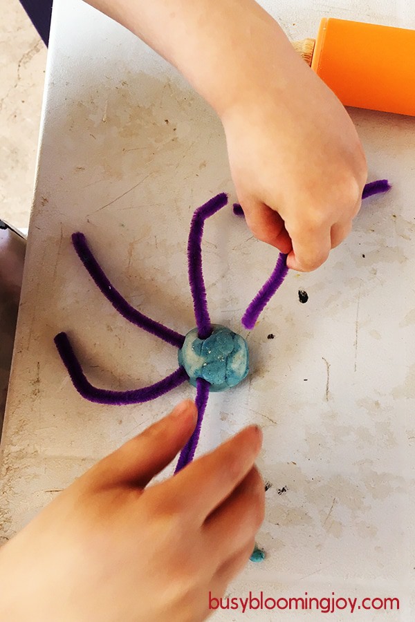 making playdough pipe cleaner spider