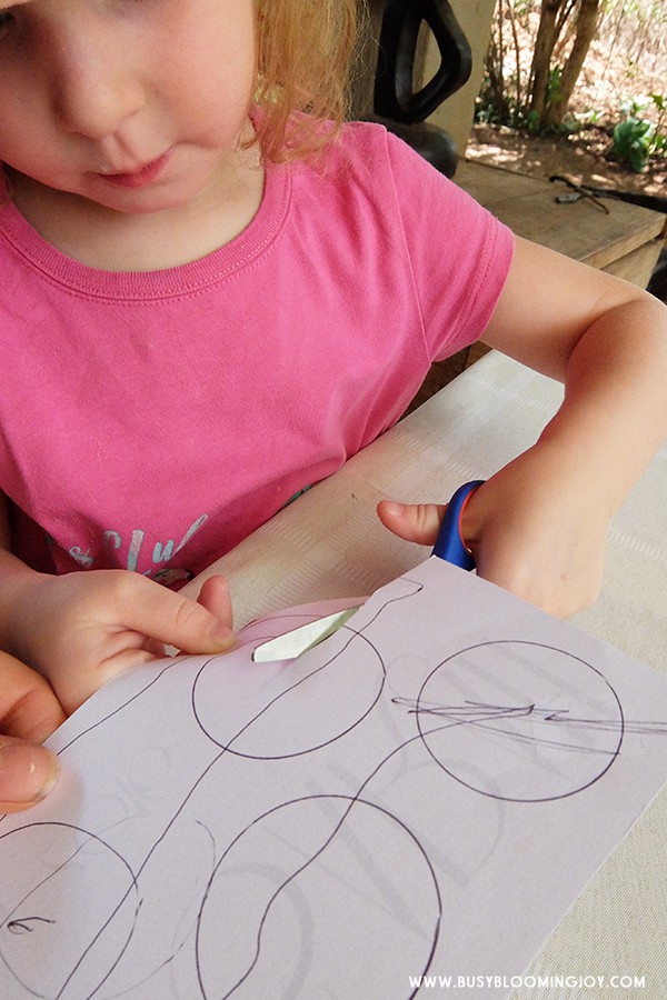 toddler cutting circles for Christmas card