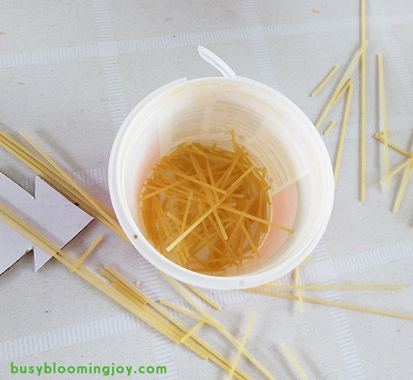 breaking spaghetti for Christmas tree ornament