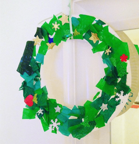 Christmas wreath craft for toddlers using paper plate and tissue paper