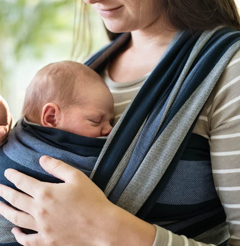 If you're wondering what to do if baby won't sleep in a bassinet, a baby wrap is one sanity-saving optionr baby w