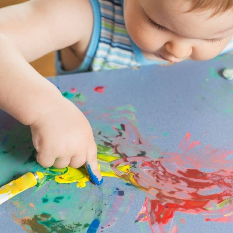blobs of paint on paper for finger painting for one year olds