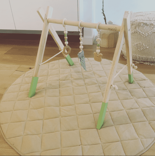 baby play gym in green nursery accessories