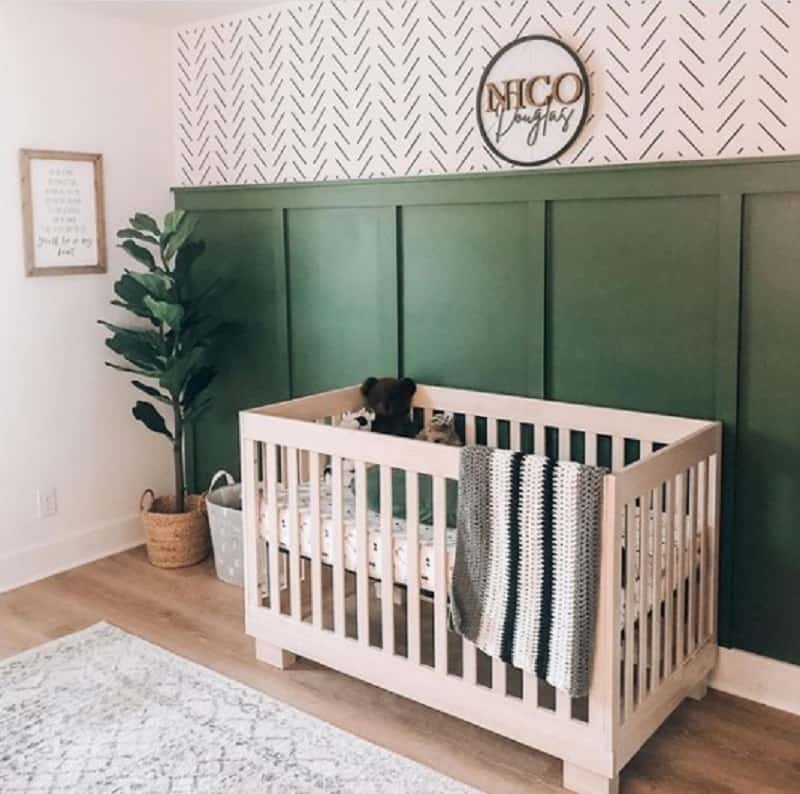 lovely dark green nursery idea with paneling and wallpaper