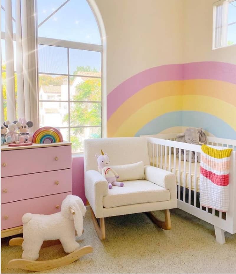 cheerfully pink and yellow rainbow nursery idea