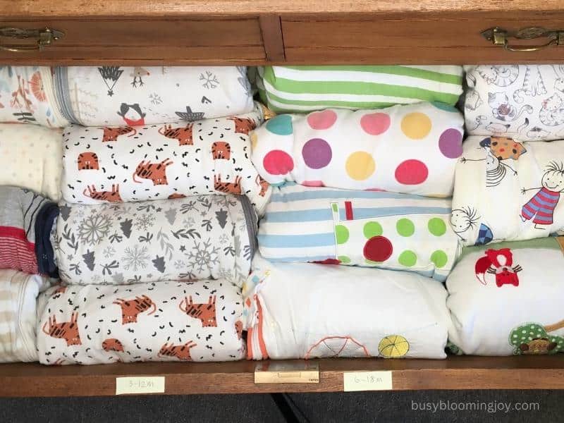 the best way to organize bulky baby clothes like sleeping bags in the dresser is to roll them 