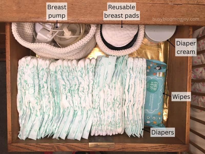 Nursery drawer organisation idea: Diapering supplies and other essential items stored in top drawer of nursery dresser