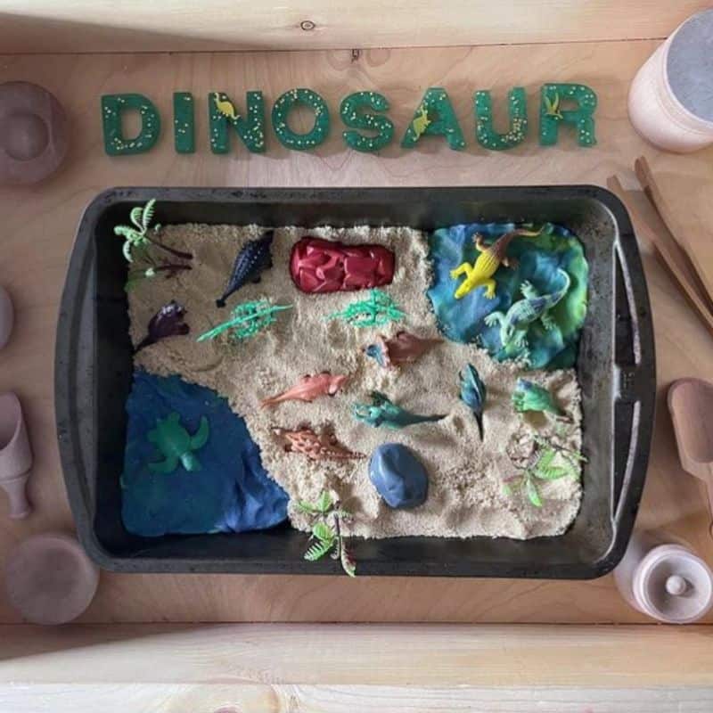 Dinosaur Sensory Bin for toddlers using brown sugar