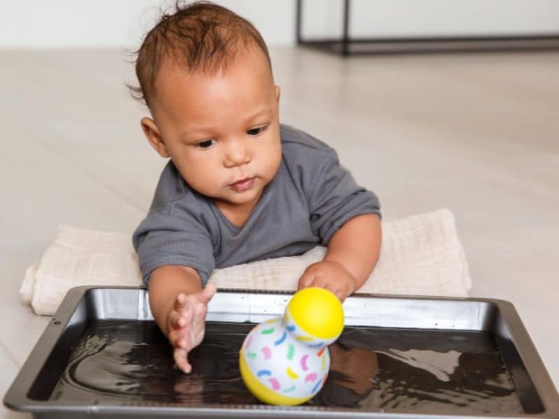 playing with water makes a fun sensory activity for 4-5 month old