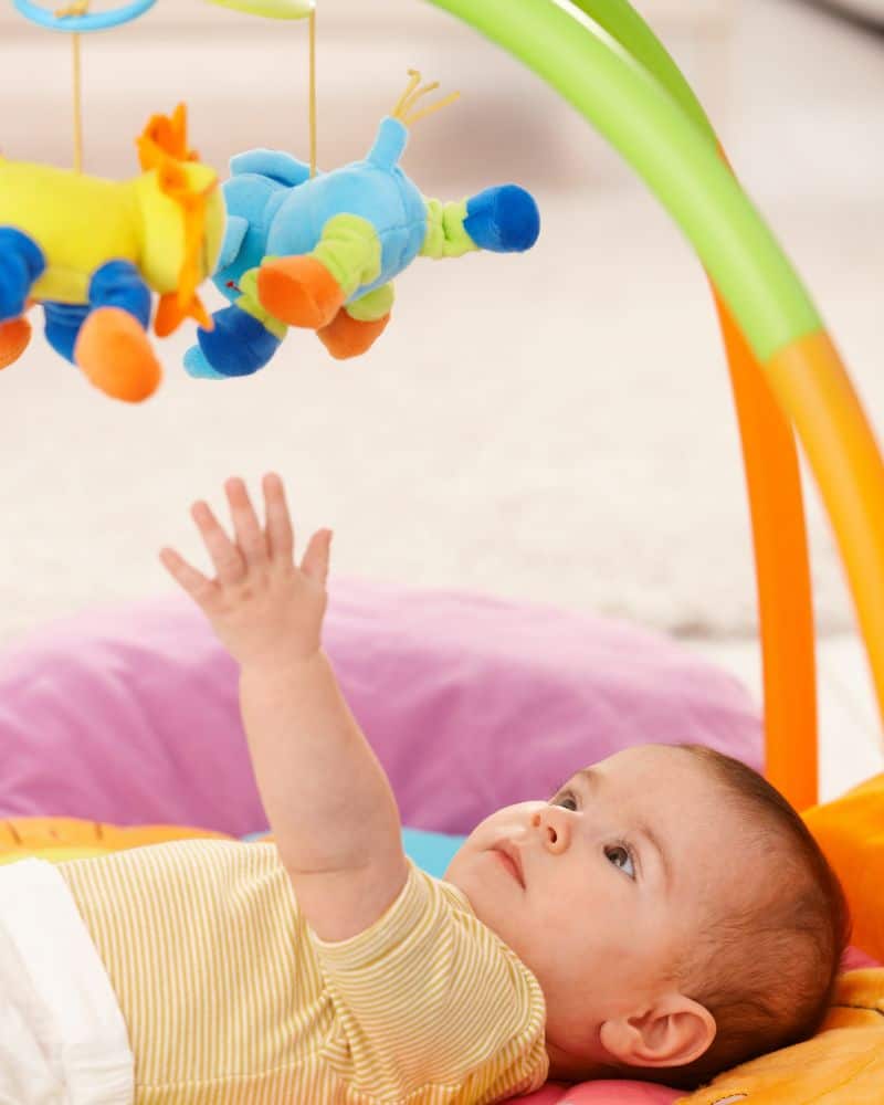 work on hand-eye coordination by letting baby reach for toys
