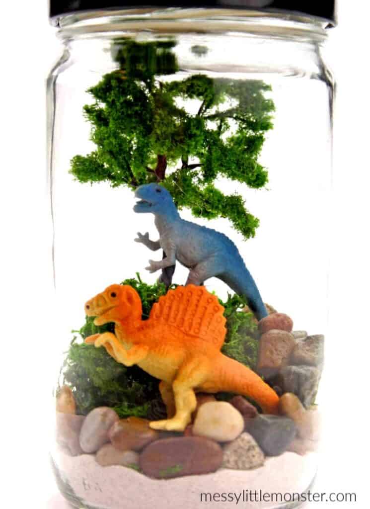 mini dinosaur terrarium in a glass jar