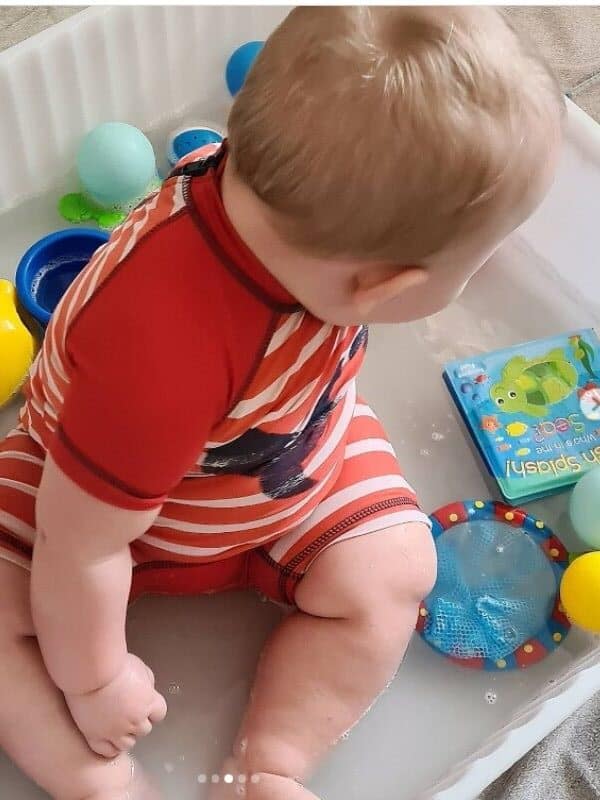 water sensory bin with balls and cups