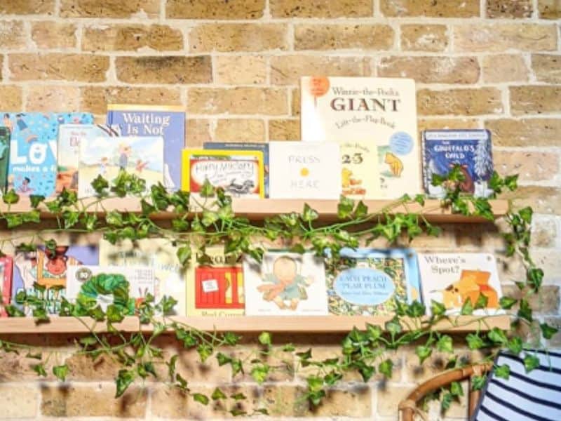 adding real or fake plants on nursery bookshelves