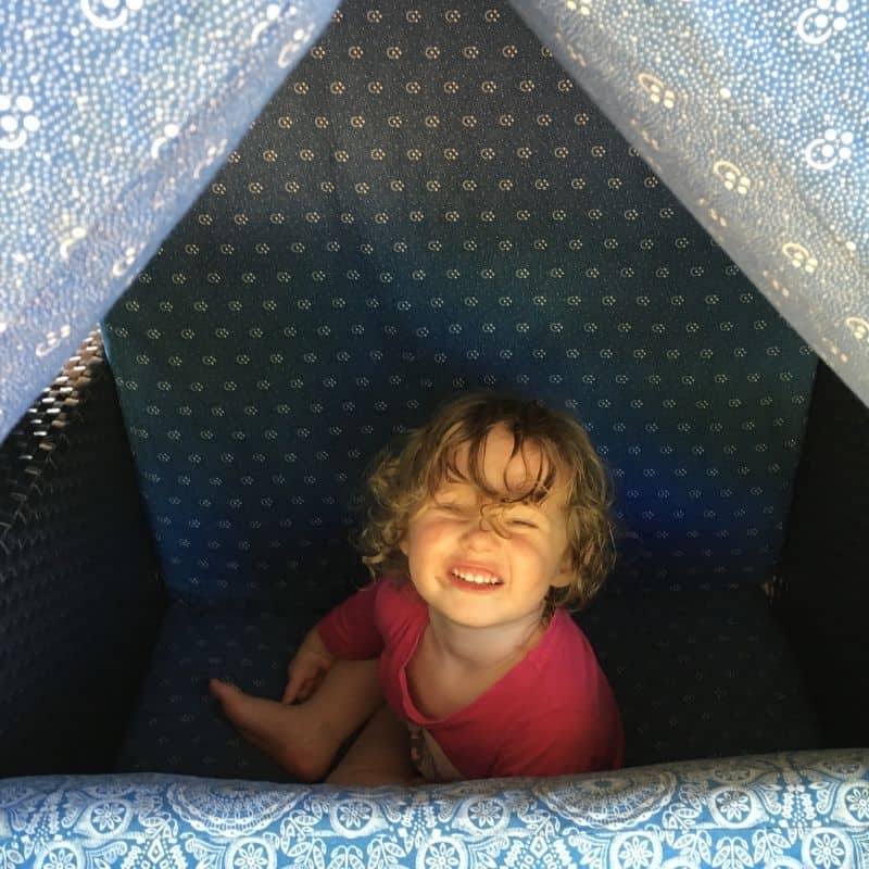 building a cushion den activity for kids inside