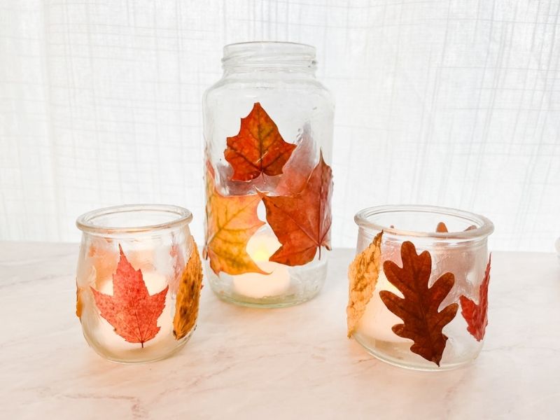 DIY lanterns are made from recycled glass jars and real, pressed fall leaves